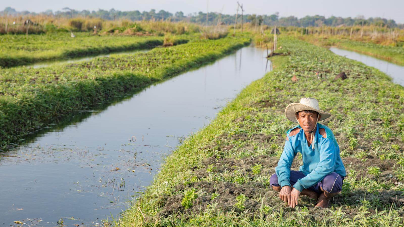 Man next to field and water culvert.