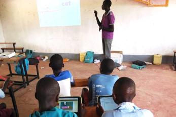 Man speaking to children in a classroom
