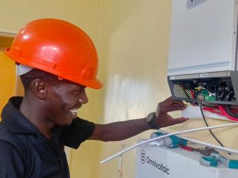 Man working on energy technology component.